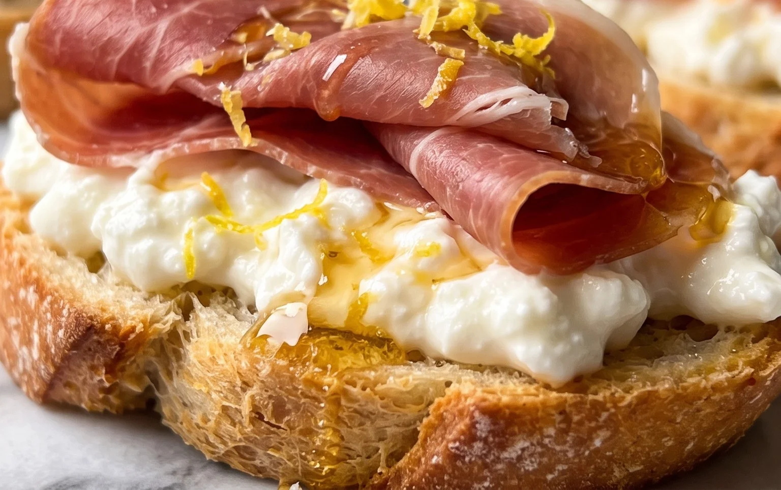 Beef Prosciutto Crostini with Burrata and Lemon Honey Drizzle