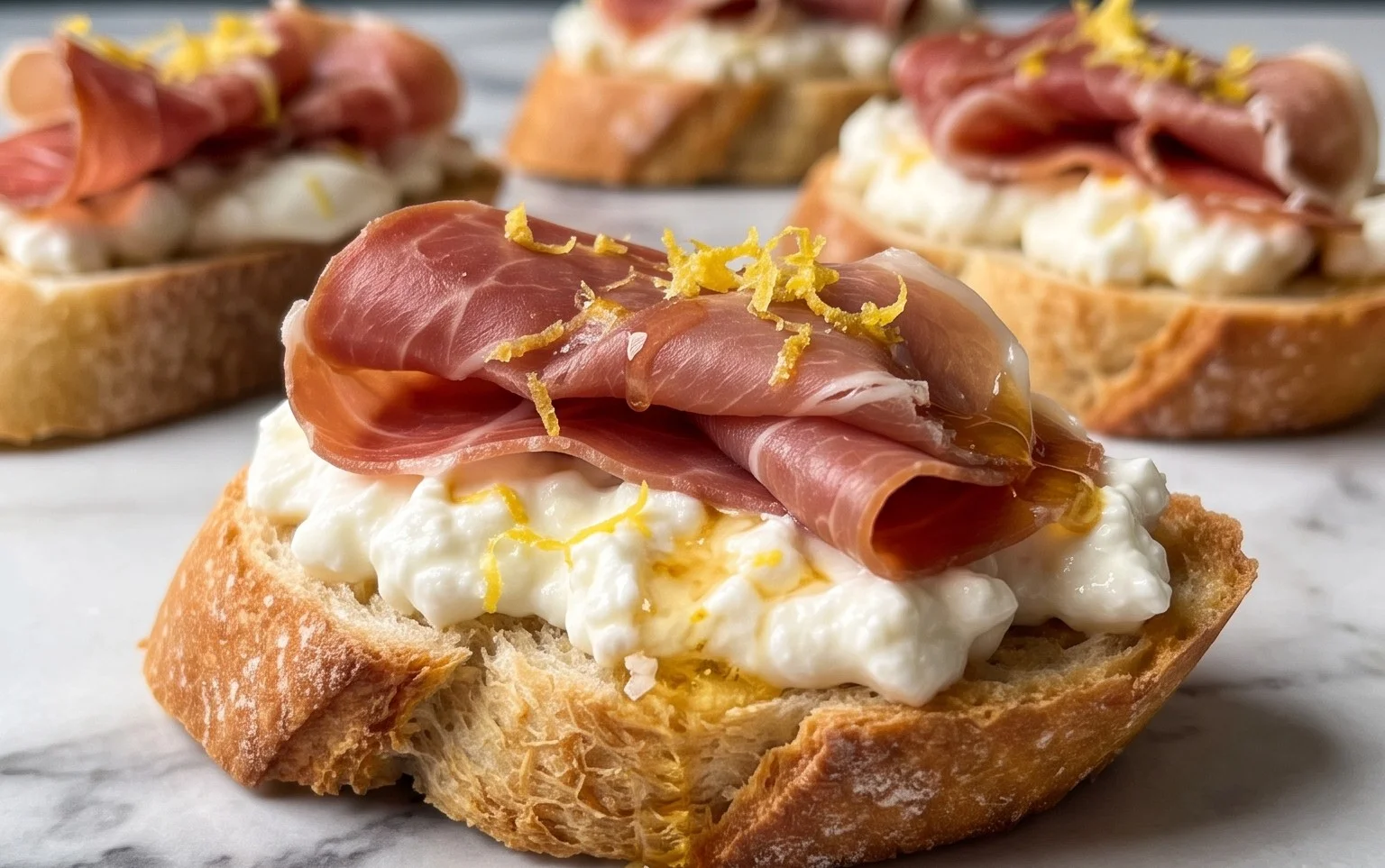 Beef Prosciutto Crostini with Burrata and Lemon Honey Drizzle